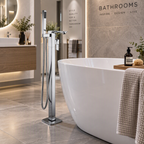 Arizona floorstanding bath shower mixer with handset in chrome beside a modern freestanding bath in a luxury bathroom showroom