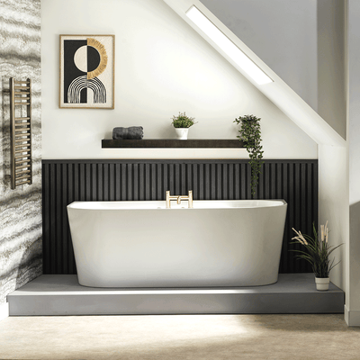White Tima rectangular freestanding bath with tapered sides in a black and white bathroom with grey and cream flooring
