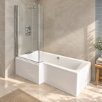 Vermont white left hand L-shaped shower bath with glass screen and matching panels in a modern stone-tiled bathroom.